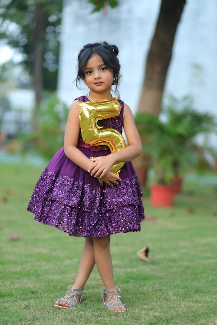 Young girl with 5-year anniversary balloon